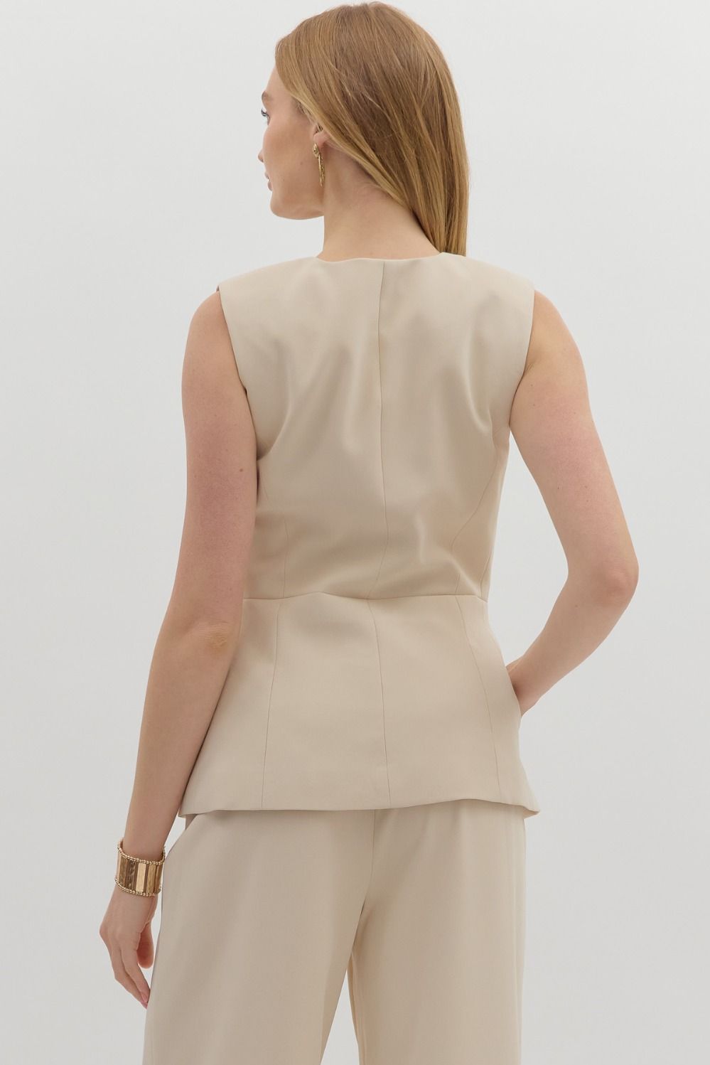The Cecilia Vest brings timeless tailoring to warm-weather style. This structured, gold-accented sleeveless vest top is perfect for polished everyday looks or elegant evenings out.