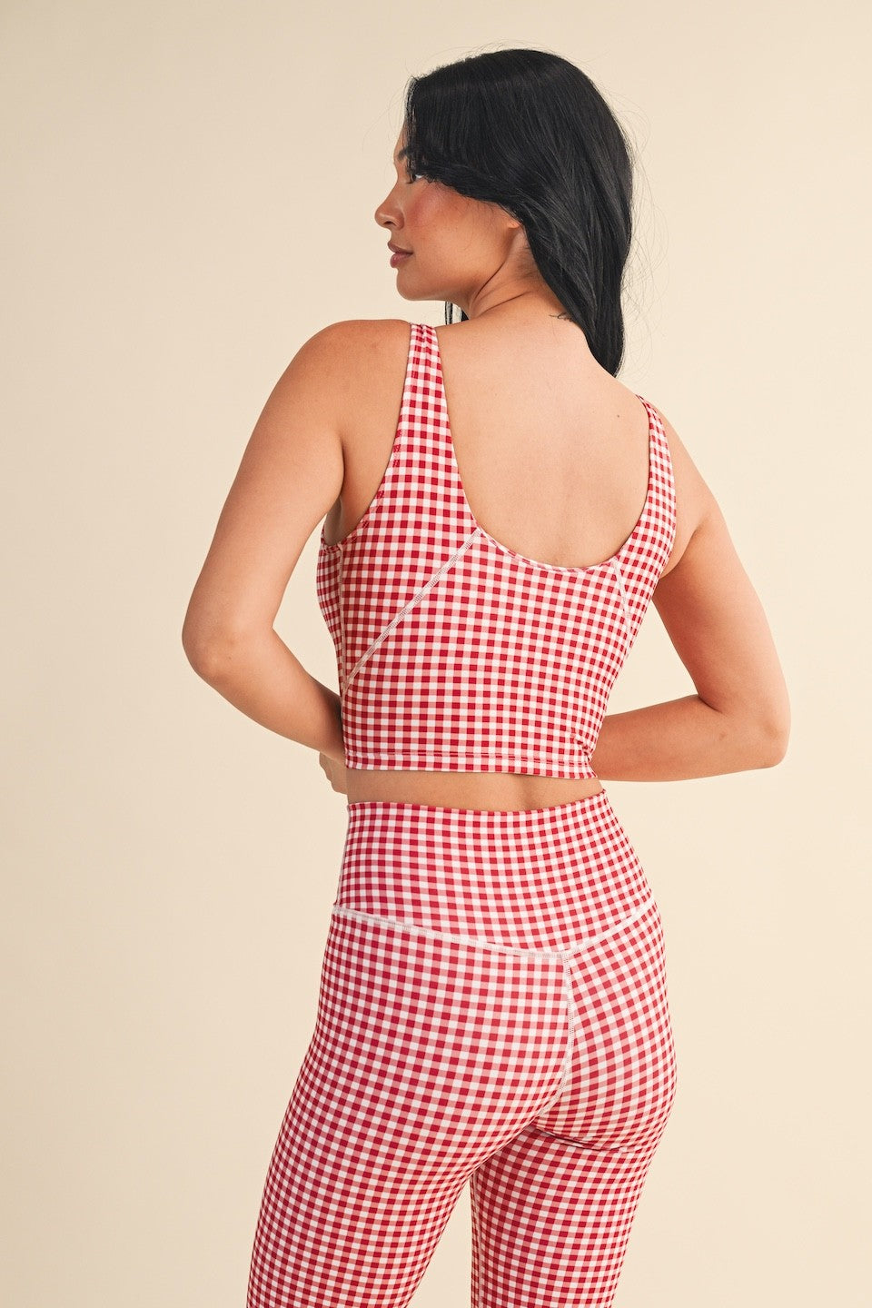 The Charlotte Gingham Performance Top features quick-drying, breathable fabric with four-way stretch and a removable bra pad for all-day comfort.