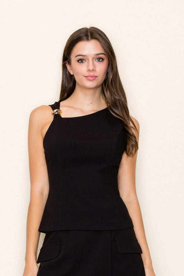 The Clarinda Top features a sleeveless silhouette with a knotted front and gold appliqué—polished, bold, and perfect for warm weather style.