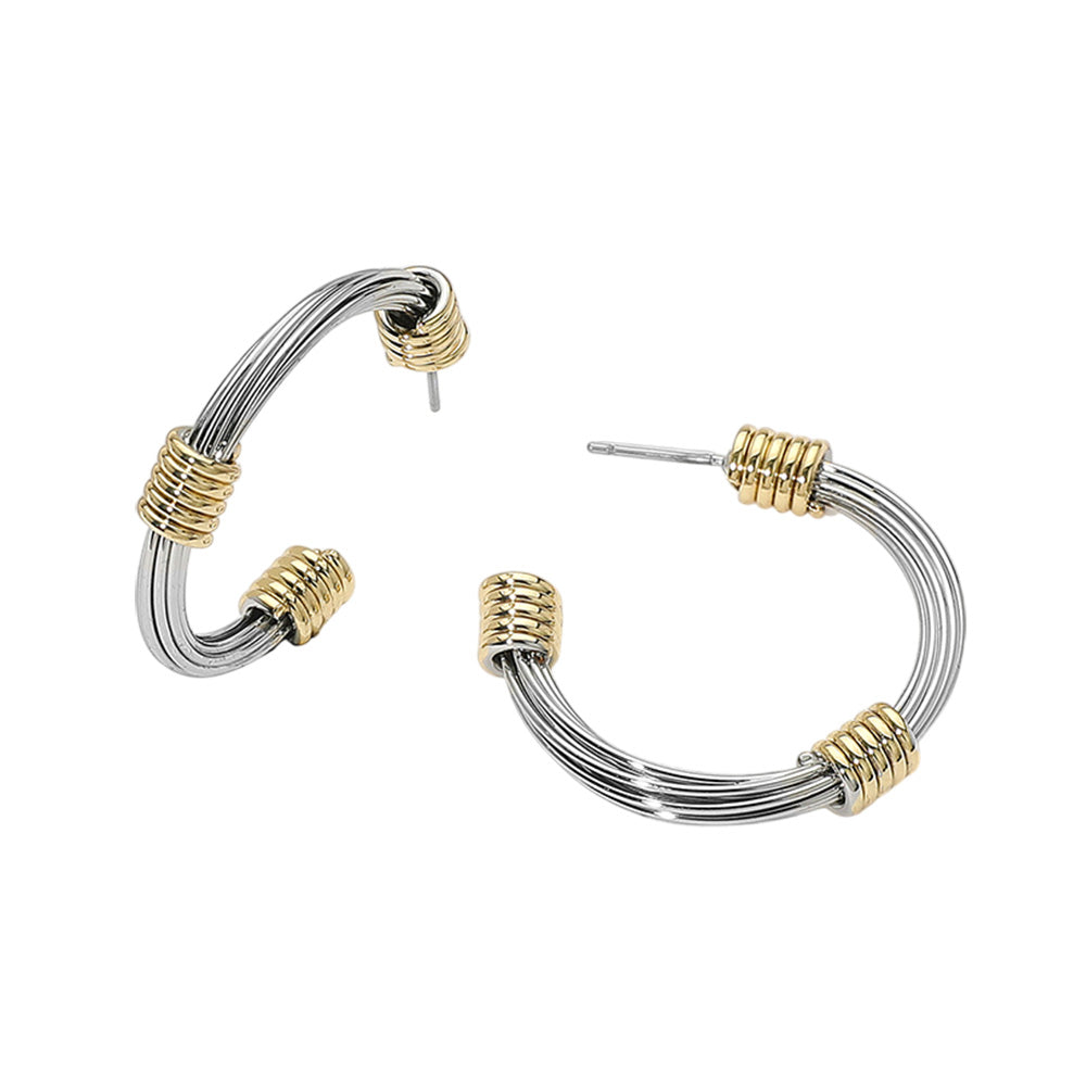 The Colette Earrings bring a sleek, modern edge to your style with wire-thin hoops and bold gold-tone coil accents.