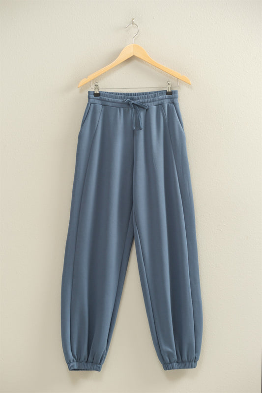 The Darcy Joggers feature ultra-soft scuba fabric, a drawstring waist, and ankle cuffs—your go-to for casual comfort with a clean, elevated fit.