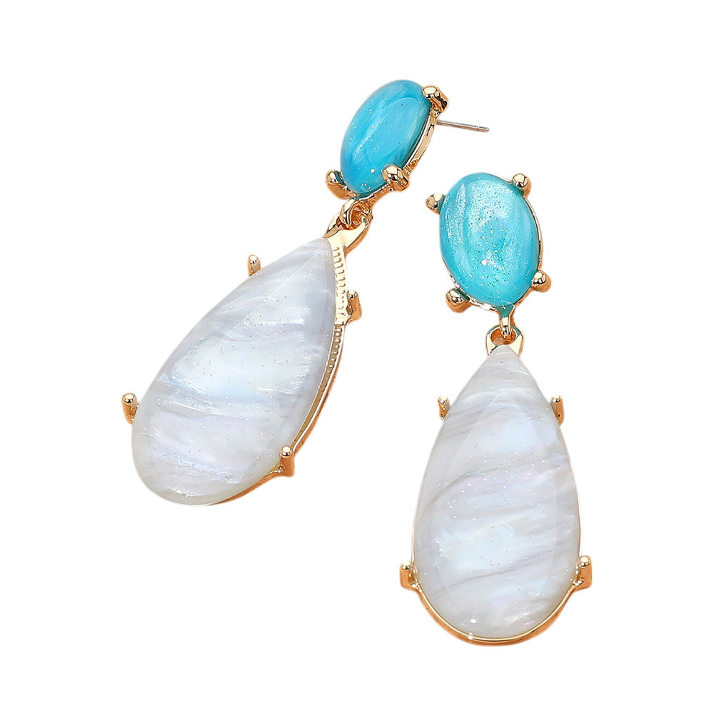 The Delia Earrings feature a long teardrop silhouette crafted from marbled resin for a lightweight, modern statement.