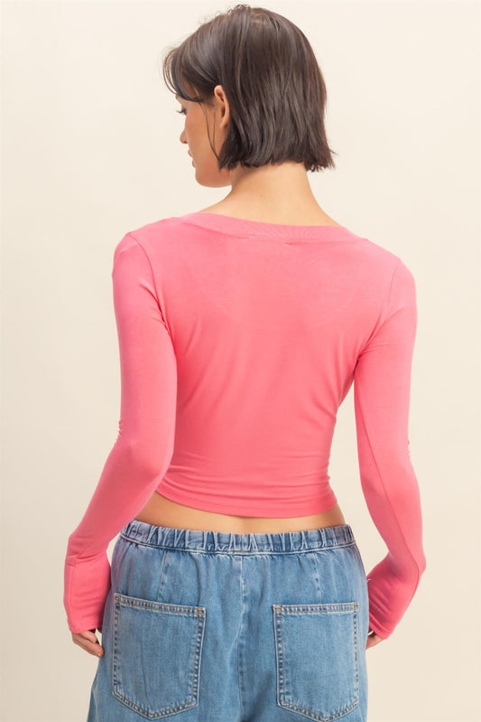 The Elin Top is a soft, cropped long sleeve with a flattering scoop neckline and fitted silhouette—perfect for everyday layering or styling solo.