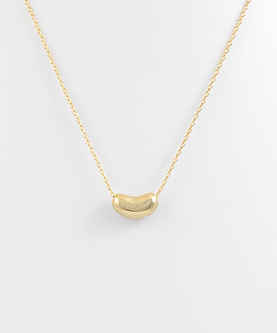 The Elsa Bean Charm Necklace features a playful bean-shaped charm with a delicate chain for everyday style.