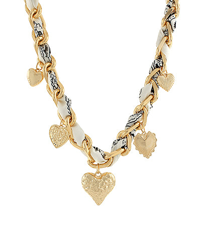 The Esme Charm Scarf Necklace combines layered metal accents and soft fabric ties for a playful, boho-inspired finish.