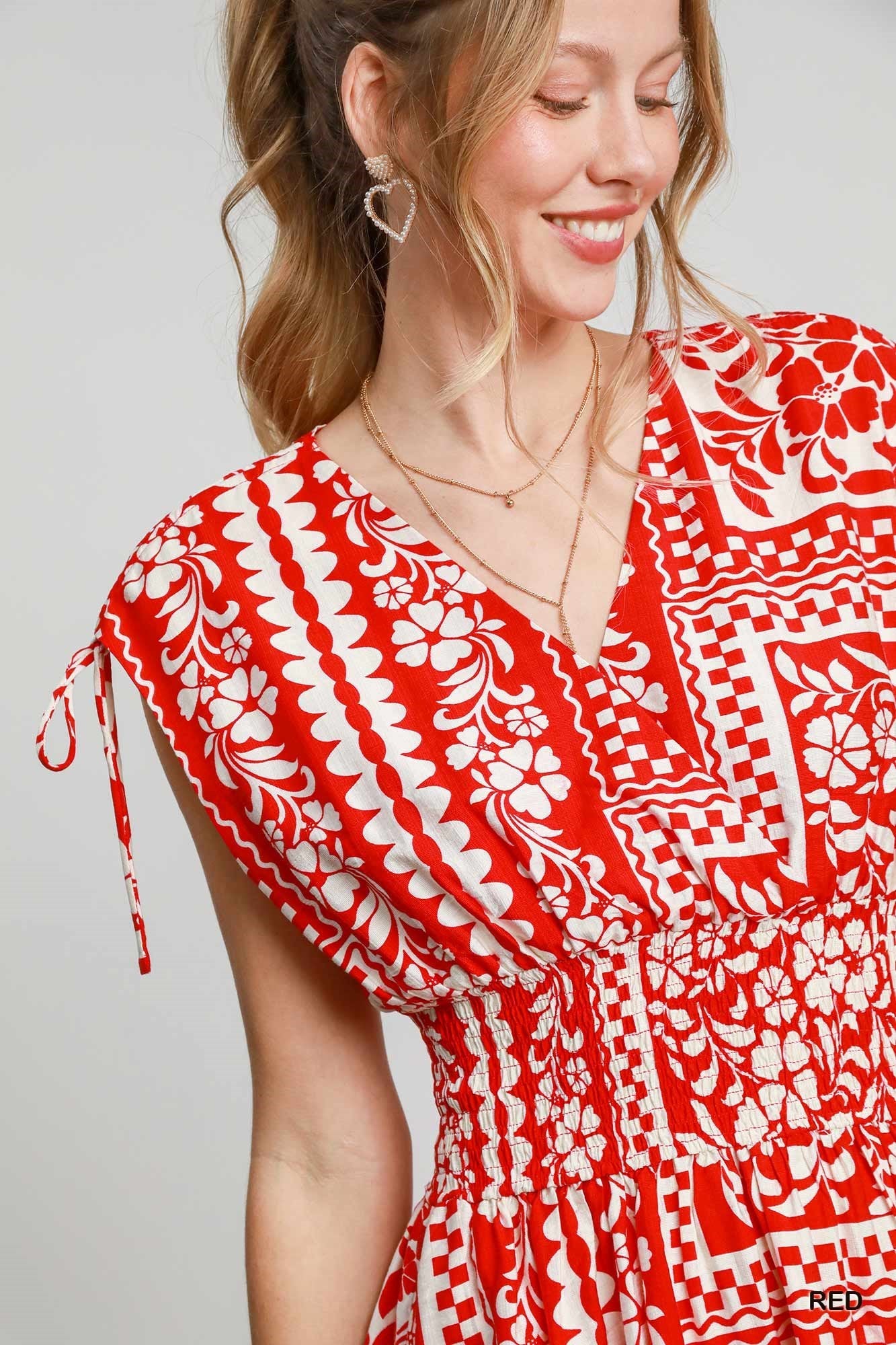 The Evangeline Boho Mini Dress features a smocked elastic waist, adjustable tie sleeves, and a breezy flared skirt with side pockets—perfect for effortless, free-spirited style.