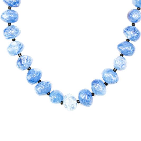 Necklace with blue beads on a white background