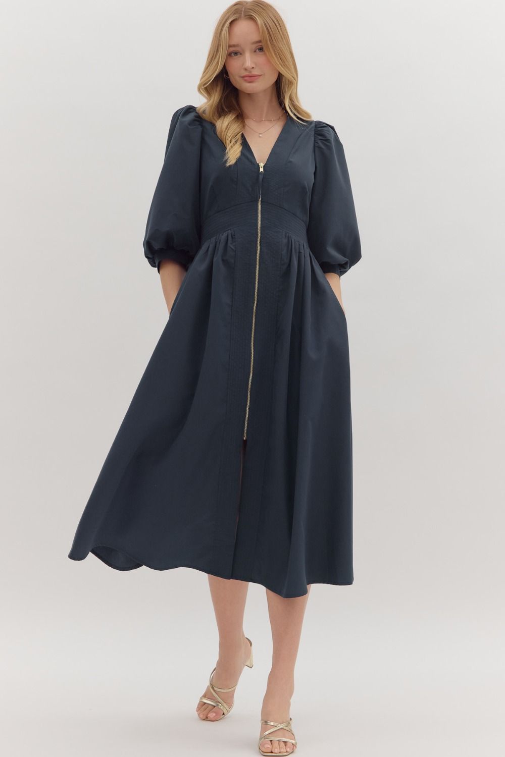 The Liora 3/4 Sleeve Midi Dress features a smocked waistband and front zipper closure for a flattering, comfortable fit.