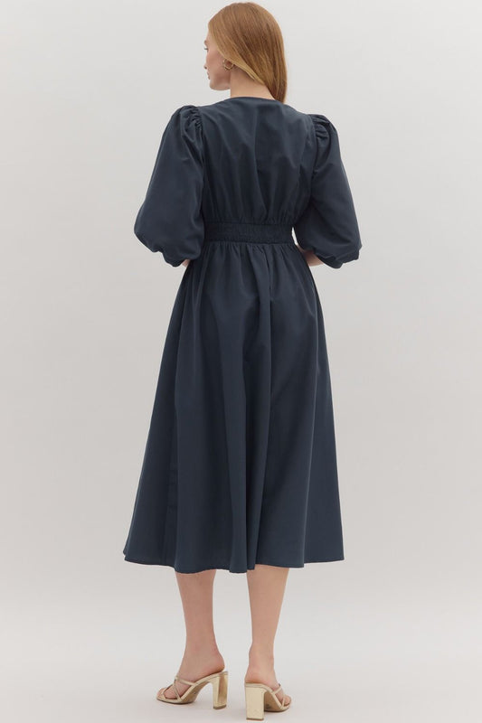 The Liora 3/4 Sleeve Midi Dress features a smocked waistband and front zipper closure for a flattering, comfortable fit.