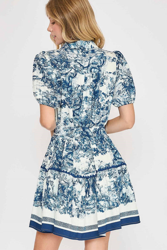 The Lorena Abstract Mini Dress features a vibrant abstract print, waist-cinching belt tie, and breezy silhouette for versatile day-to-night style.