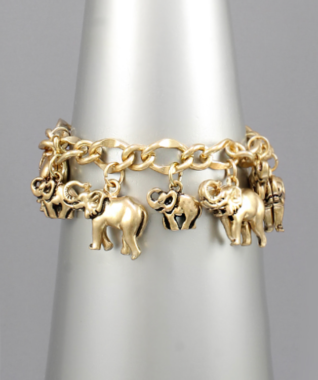 A vibrant gold-toned charm bracelet adorned with multiple detailed elephant charms of various sizes and designs, some solid and some with cutout patterns, all suspended from an intricate chain.