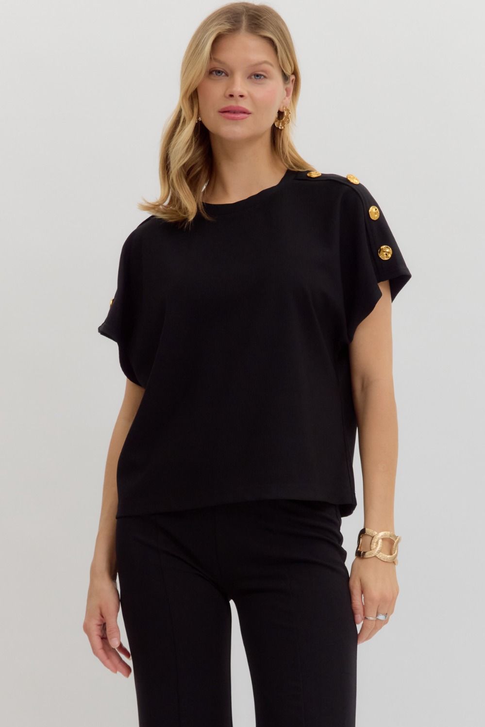 The Mabel Top is a classic crewneck pullover with a twist—featuring elegant gold button accents and a soft, lightweight knit for everyday ease and polish.