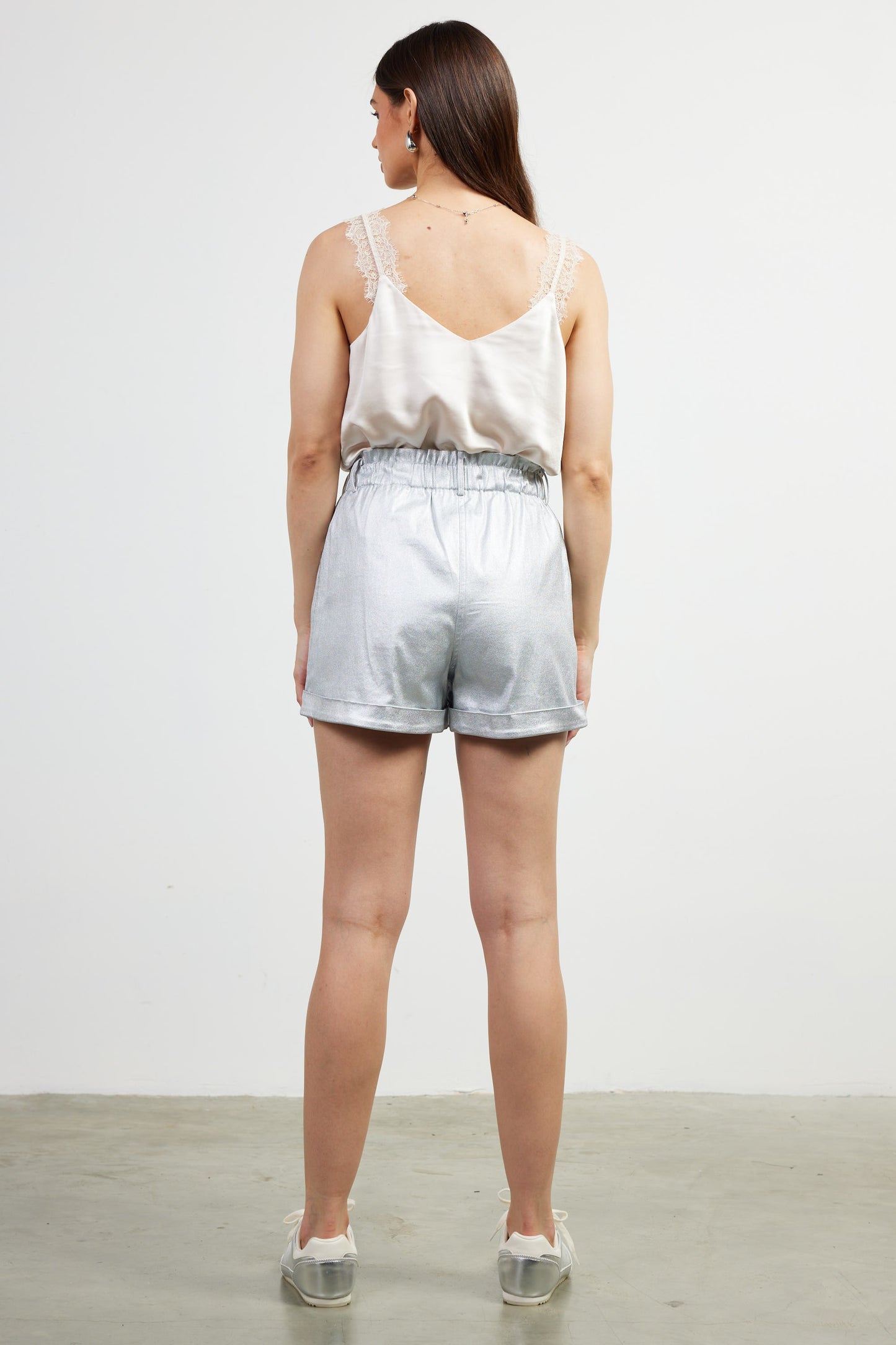 The Odessa Shorts shimmer with silver and bronze tones, featuring a comfortable elastic waistband and sleek, flexible fit—perfect for dressing up or down.