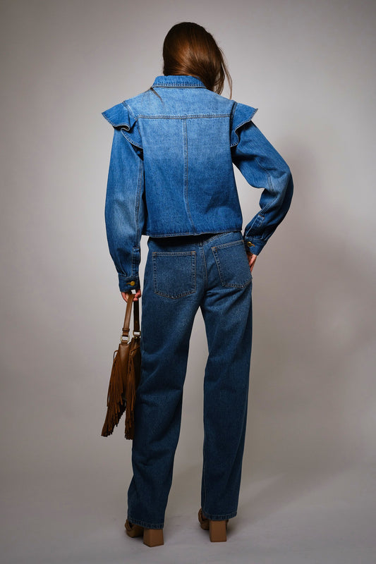 The Theodora Jacket combines contrast denim, gold buttons, and bold ruffle trim for a feminine twist on the classic jean jacket.