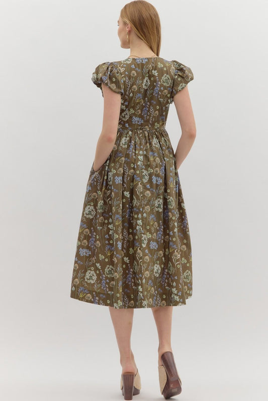 The Verona Dress is a romantic floral midi with puff sleeves, a smocked top, and bow detail—perfect for garden parties, weekend strolls, or everyday elegance.