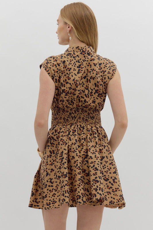 The Winona Dress blends bold leopard print with breezy comfort, featuring a zip-front neckline, smocked waist, and soft cotton lining for a fierce yet flattering look.
