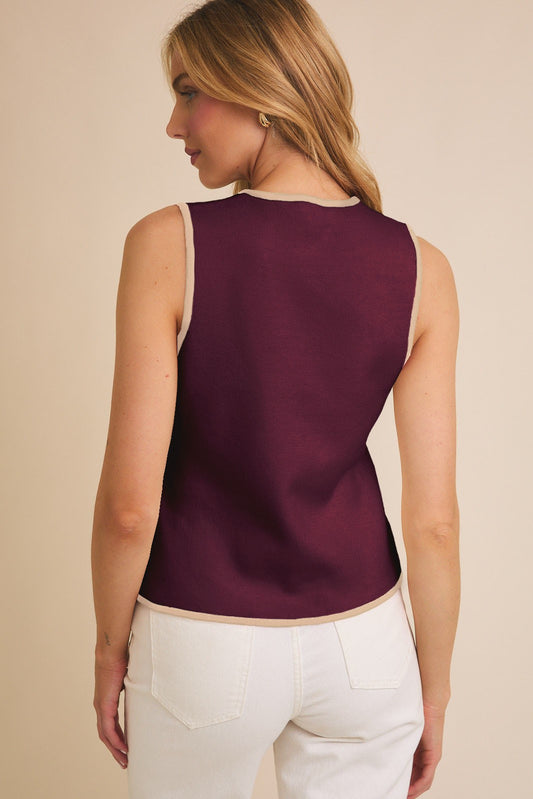 Timeless sleeveless knit vest with a crew neckline and button-down front.
