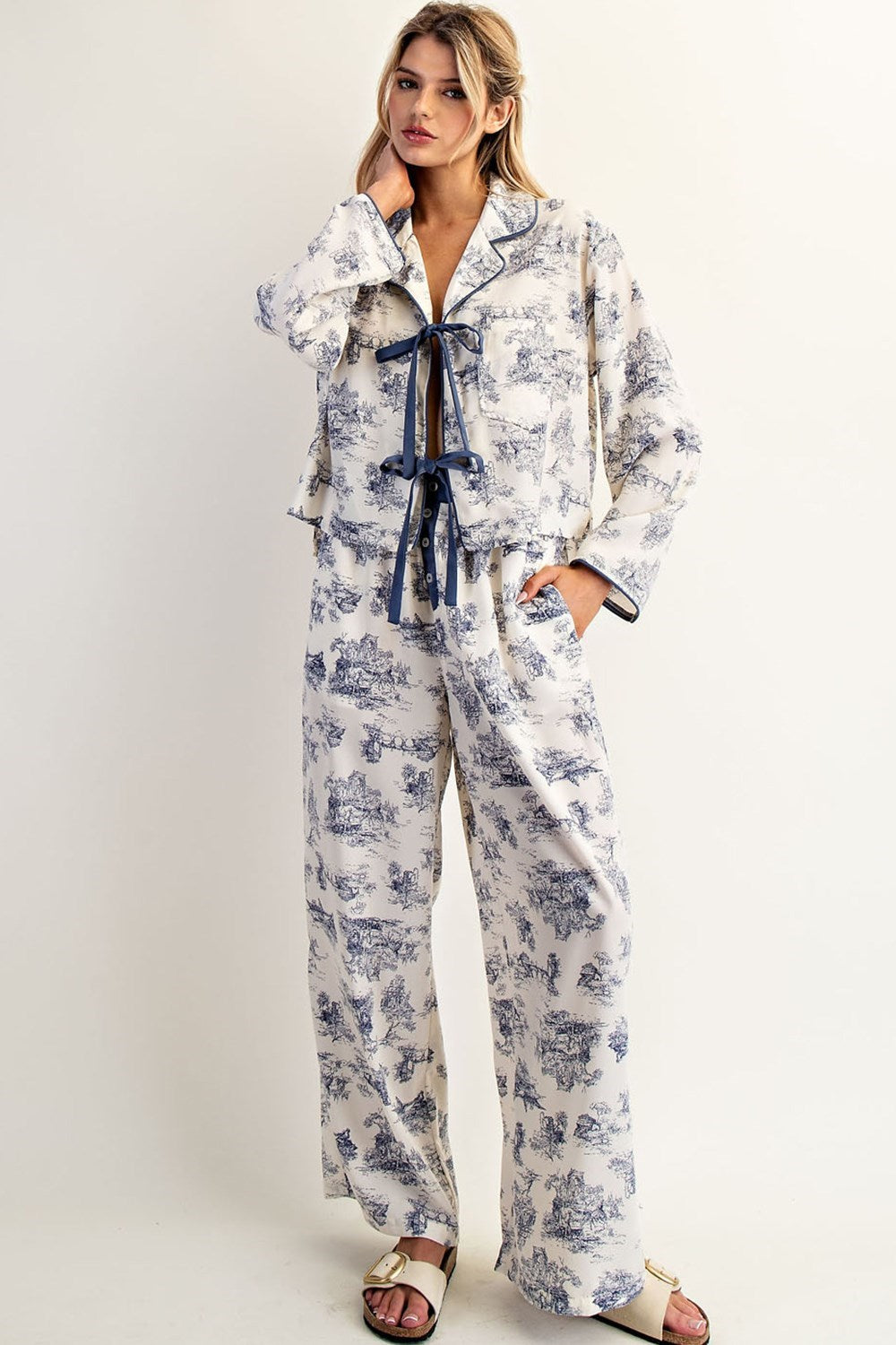 Two-piece toile print pajama set with bow tie top and contrast details.