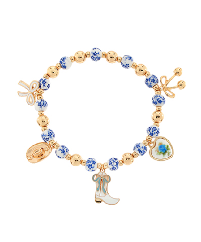 Western Charm Beaded Bracelet featuring gold beads, blue and white ceramic floral beads, and western-themed charms.