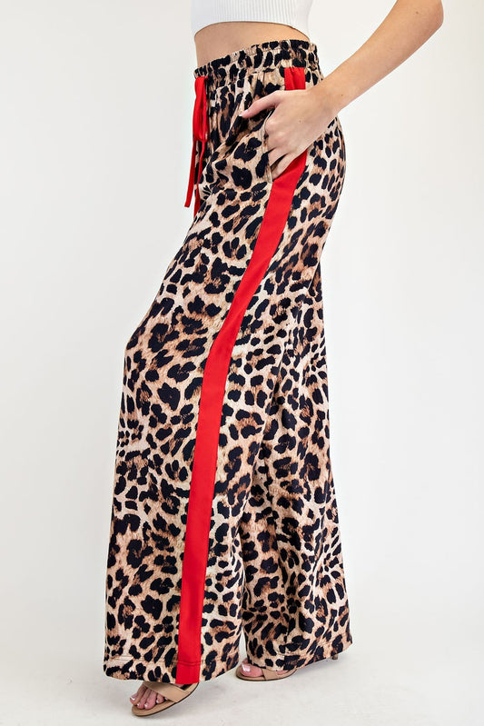 leopard print wide-leg pants with red side stripe.