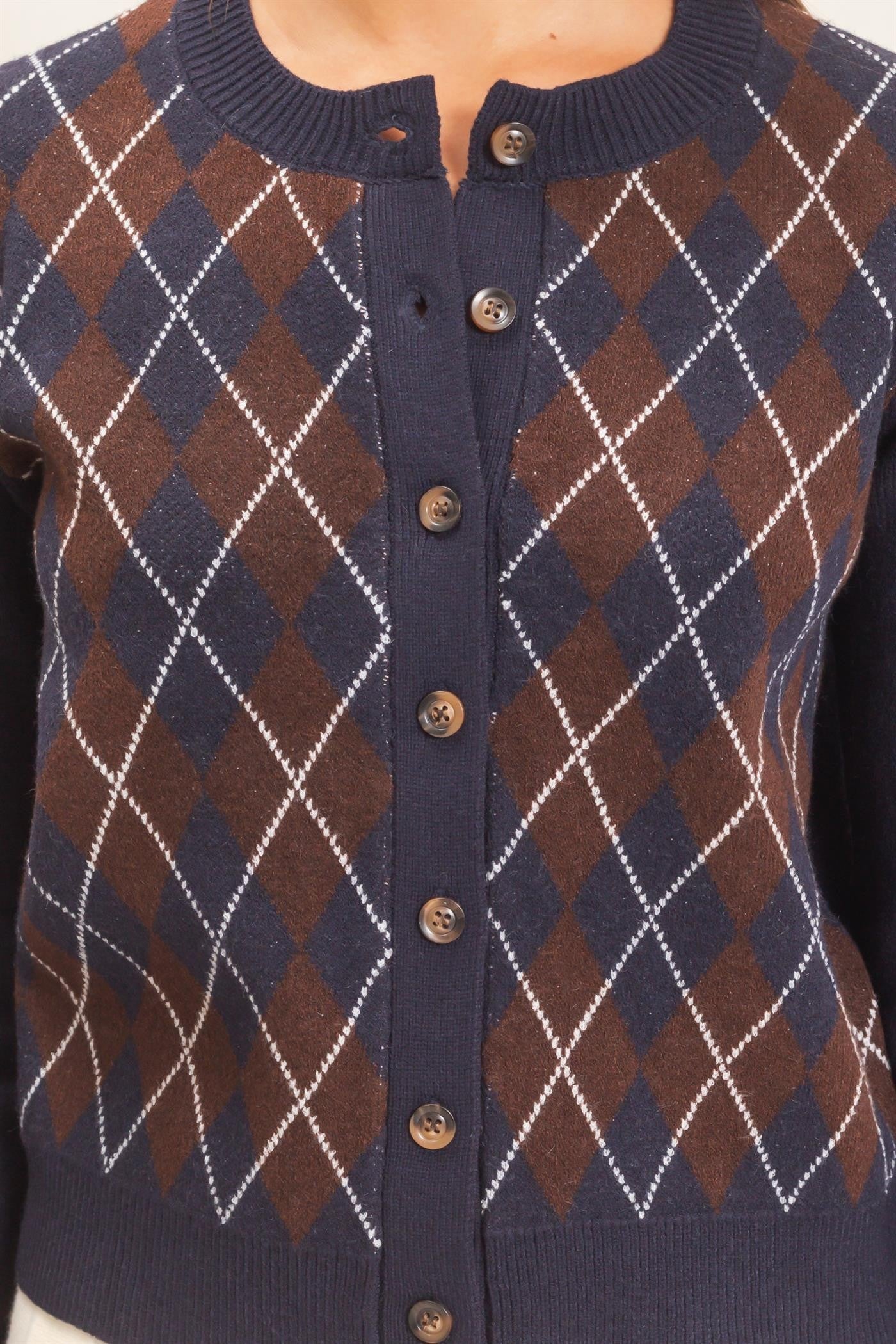A timeless argyle cardigan with a relaxed silhouette, ribbed crew neckline, and classic button-front closure for polished, effortless layering.