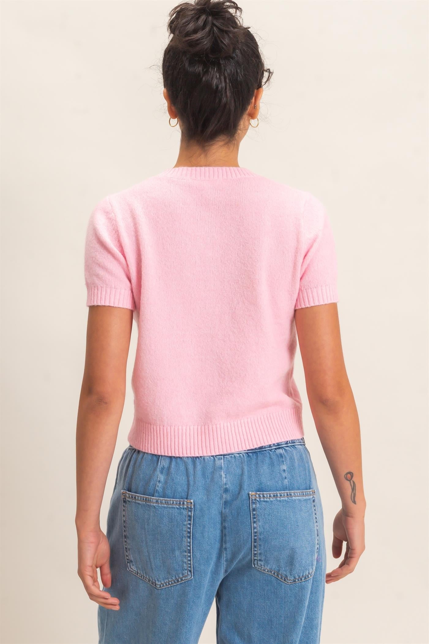 A polished, figure-flattering short-sleeve sweater with classic ribbed texture and button-front styling that makes effortless everyday dressing feel elevated.