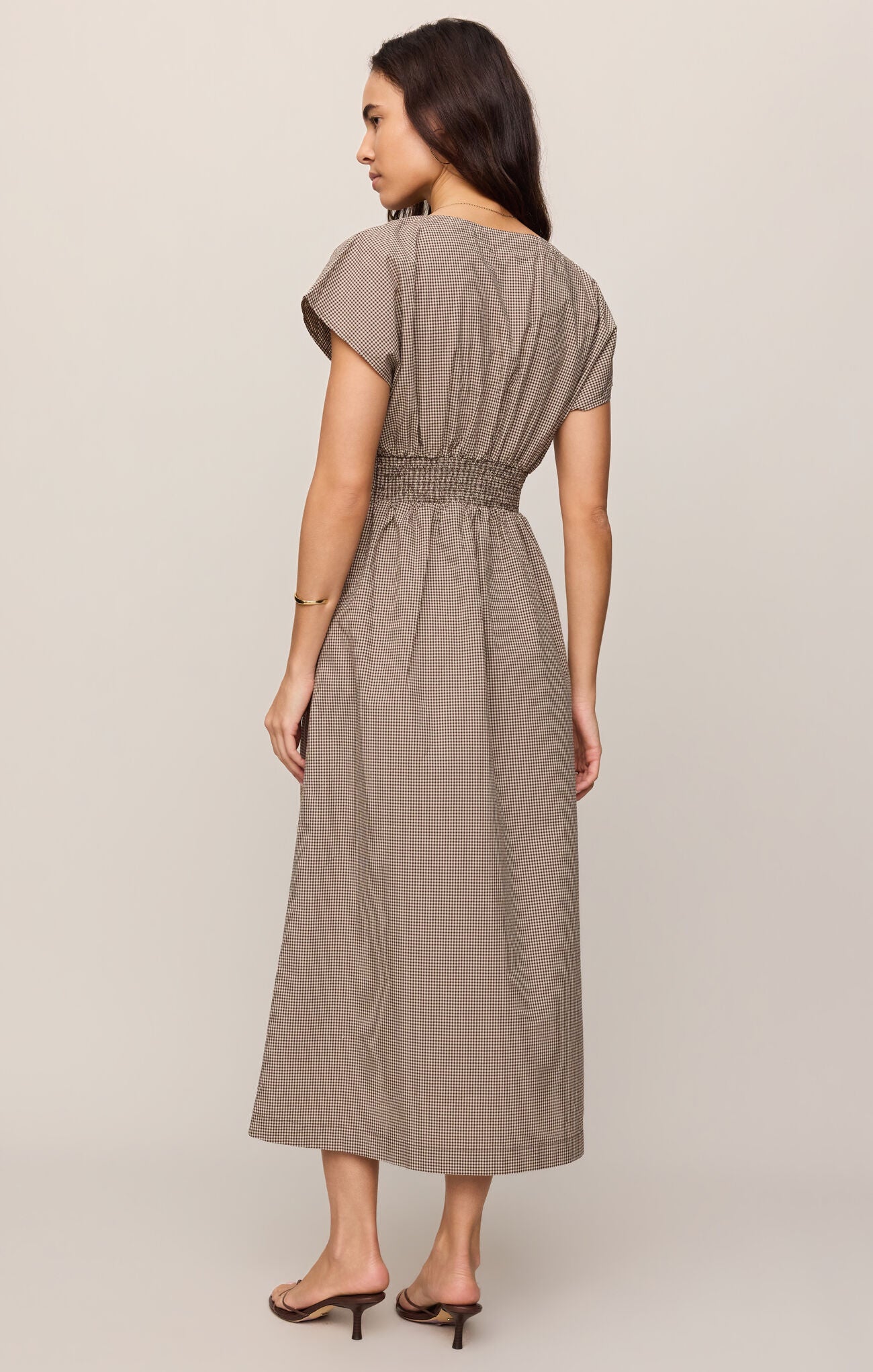 A cotton poplin shirt dress featuring a classic gingham print, flattering V-neckline, and button-front design for effortless everyday sophistication.