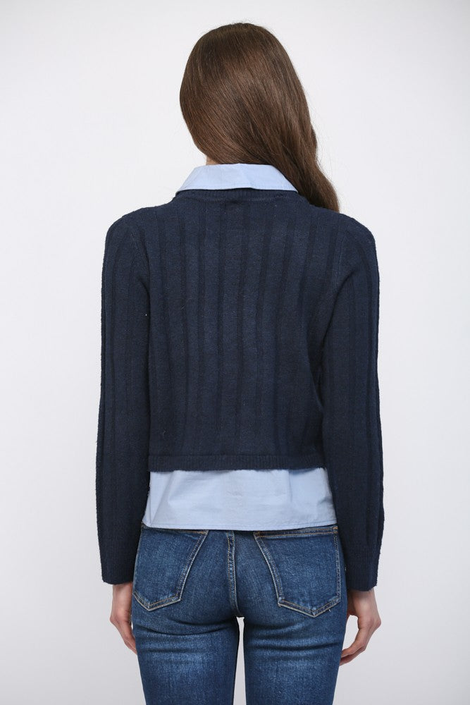 A cozy sweater featuring layered look denim details, patch pockets, and an effortlessly chic mixed-media design.