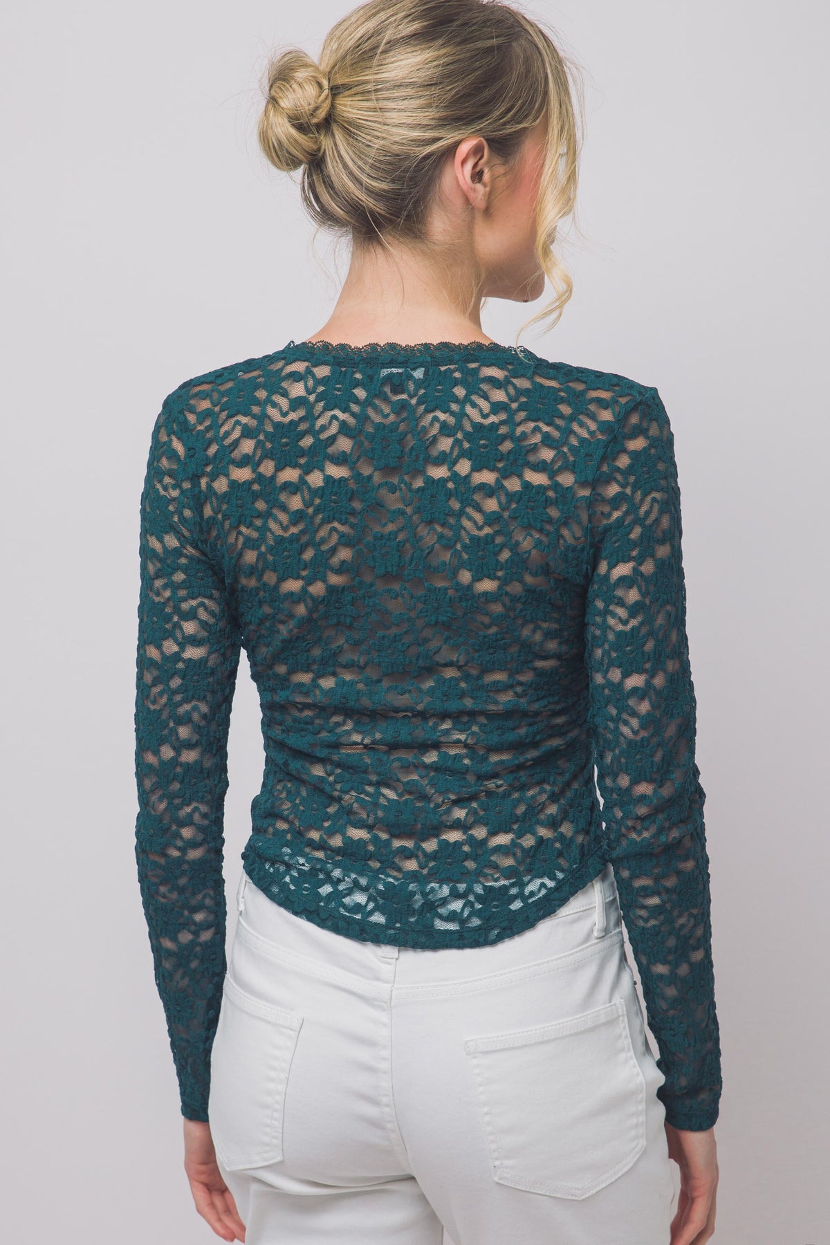 A romantic sheer floral lace top featuring long sleeves, a scalloped V-neckline, delicate trim details, and matching front buttons for an effortlessly feminine look.