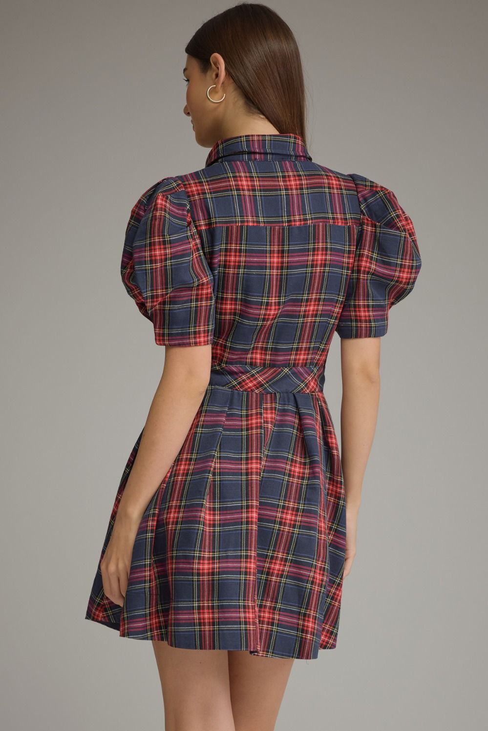 A charming plaid mini dress featuring feminine puff sleeves, a classic shirt collar, and a self-tie waist for a flattering silhouette.