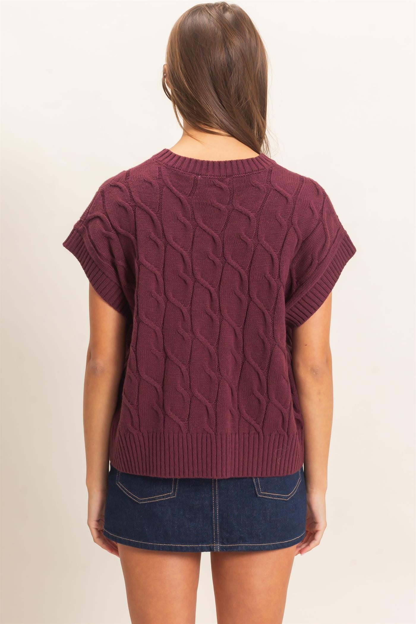 A timeless cable knit sweater featuring a classic crew neckline and cap sleeves for an effortlessly polished look you'll wear year-round.
