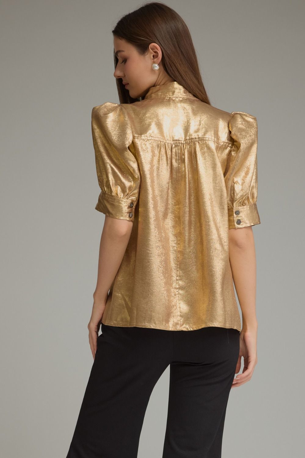A polished metallic-finish top featuring short puff sleeves, a sophisticated high neckline, hidden front buttons, and button cuffs for an elevated statement look.