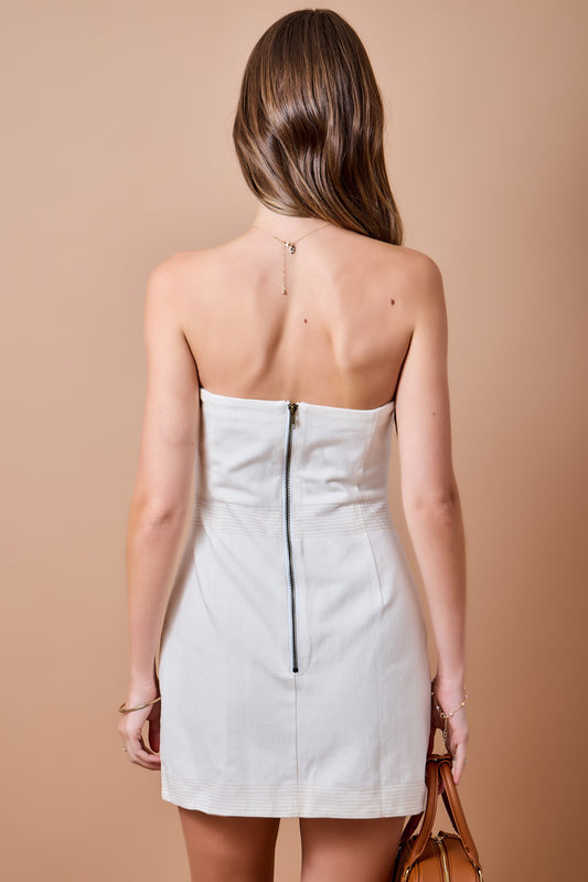The Colette Strapless Cutout Dress makes a sleek statement with a fitted silhouette, waist cutout, and contrasting topstitch detail.