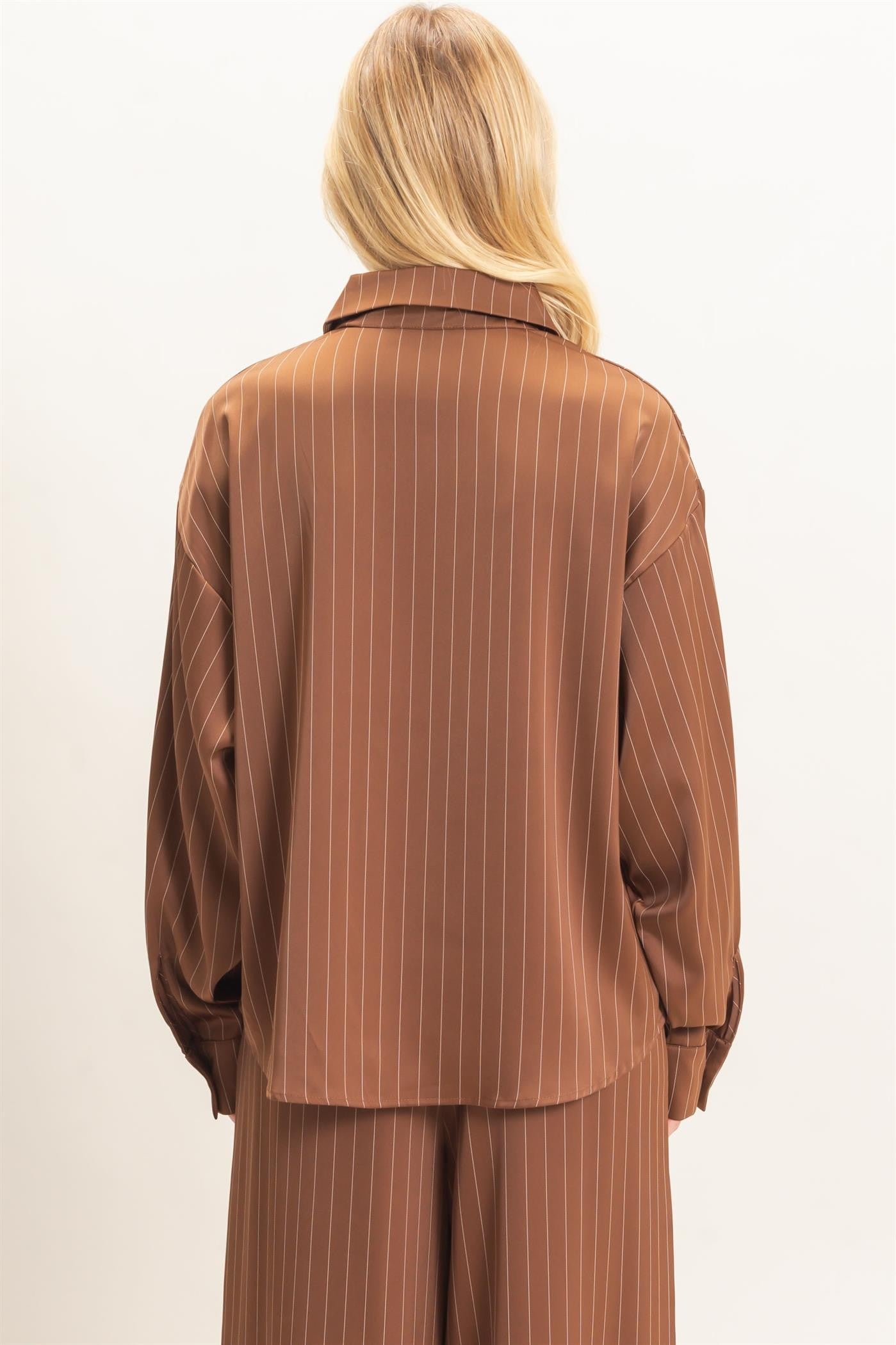 A relaxed striped button-up blouse with a classic spread collar, chest pocket, and button cuffs for effortless polished style.