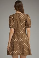 A playful cotton polka dot mini dress featuring feminine puff sleeves, a flattering V-neckline, and convenient side pockets.