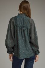 A lightweight polka dot blouse featuring a feminine ruffled neckline, button-front detail, and elegant long sleeves for effortless boutique style.