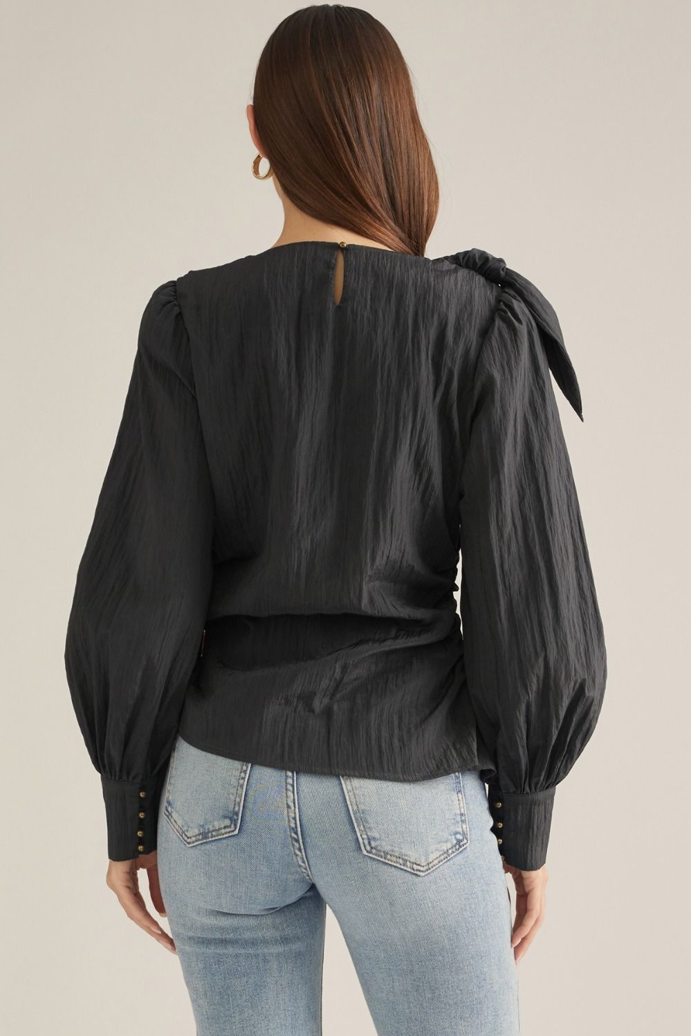 Elevate your wardrobe with this chic long-sleeve blouse featuring a straight neckline, feminine shoulder tie, and flattering side-wrap detail.