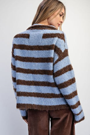 A cozy textured knit cardigan featuring a relaxed slouchy fit, dropped shoulders, and playful mismatched buttons for a unique finishing touch.