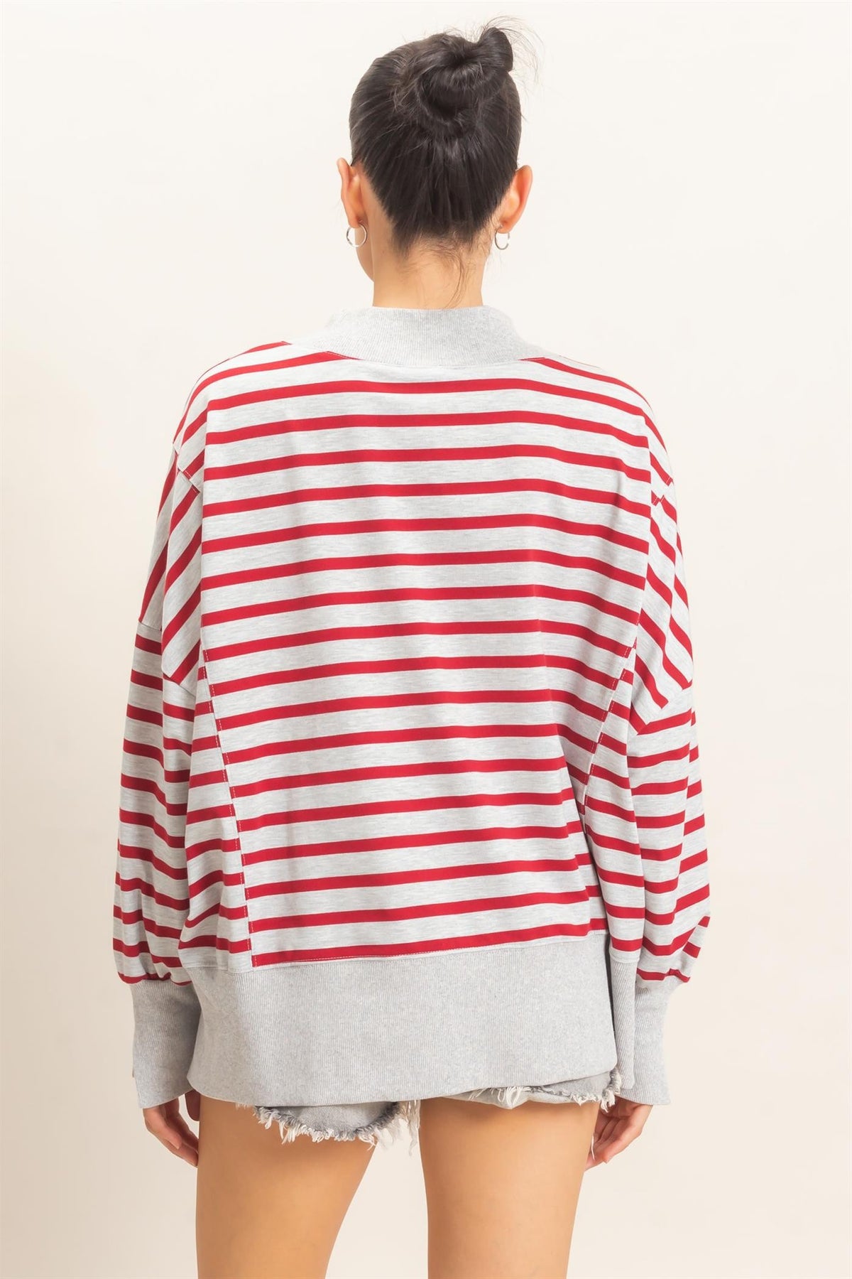 A relaxed striped sweatshirt featuring a cozy mock neck, ribbed cuffs, and a split hem for effortless everyday style.