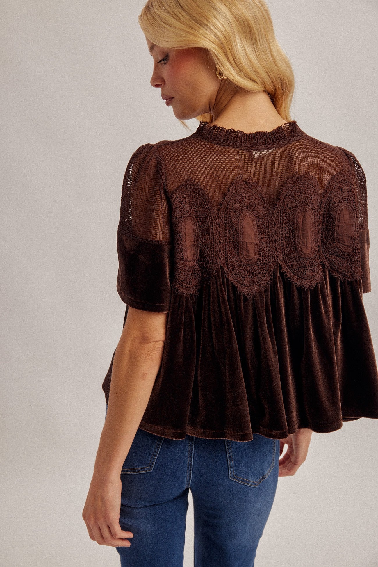 A romantic velvet contrast top featuring delicate scalloped mesh and crochet lace details for a feminine, elevated look.