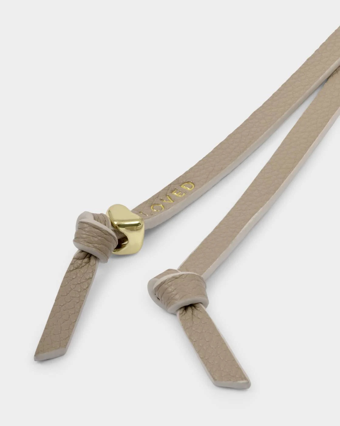 Our Bow Charm Keyring features a sweet bow-shaped design, stamped with the sweet sentiment ‘Loved’. Finished with gold-tone signature charm detailing.