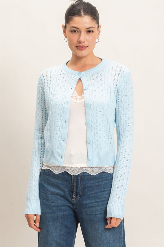 A timeless cable knit cardigan with a classic crew neckline, button-front closure, and textured detailing for cozy, polished style.