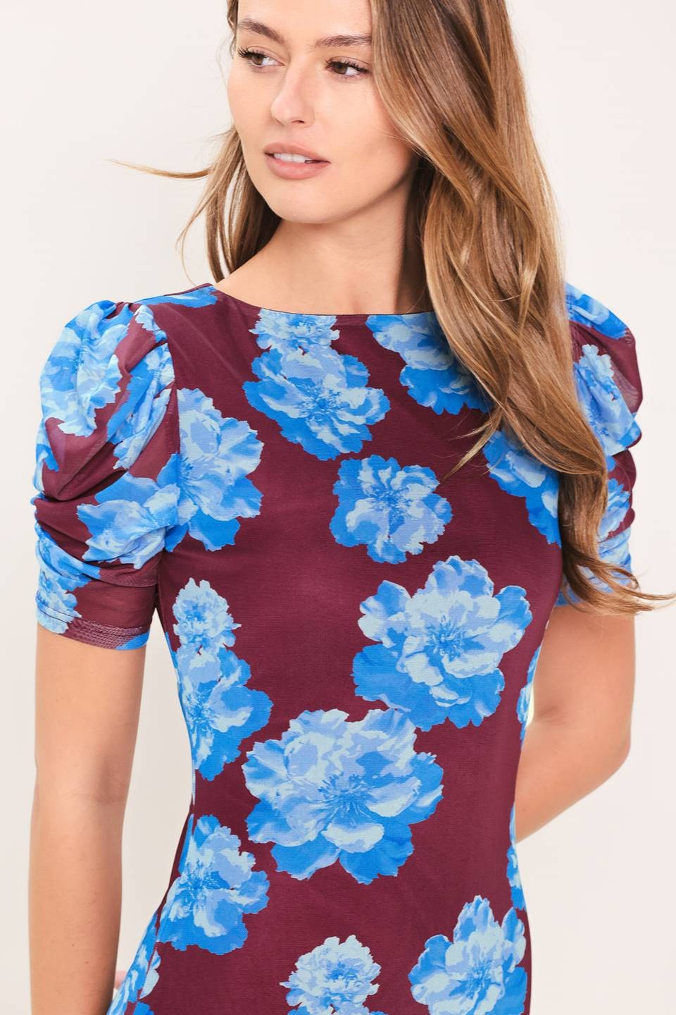 Woman wearing a dress with blue floral pattern