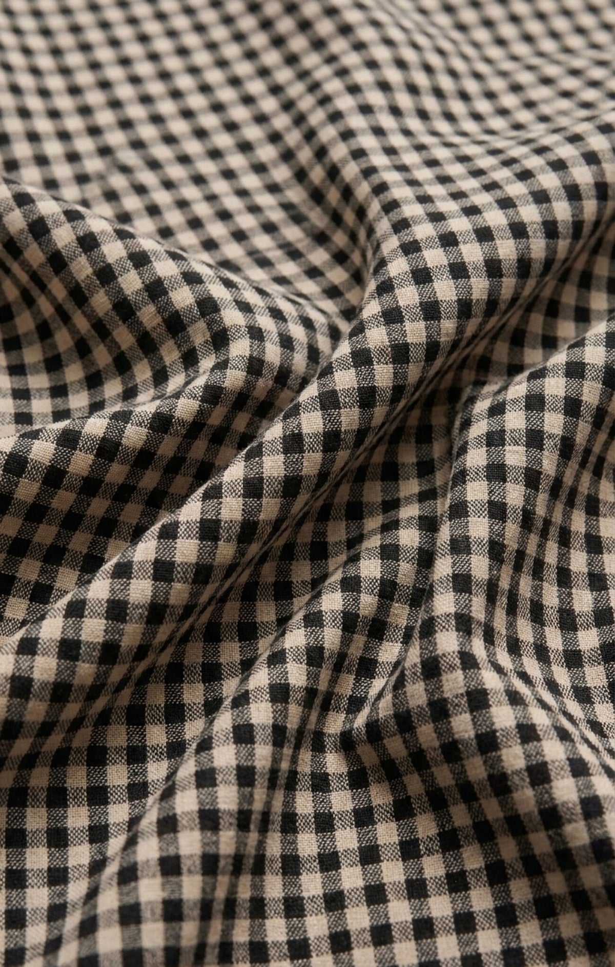 A breezy plaid linen-blend bubble top featuring a classic crew neckline and a flattering billowy silhouette for effortlessly elevated warm-weather style.