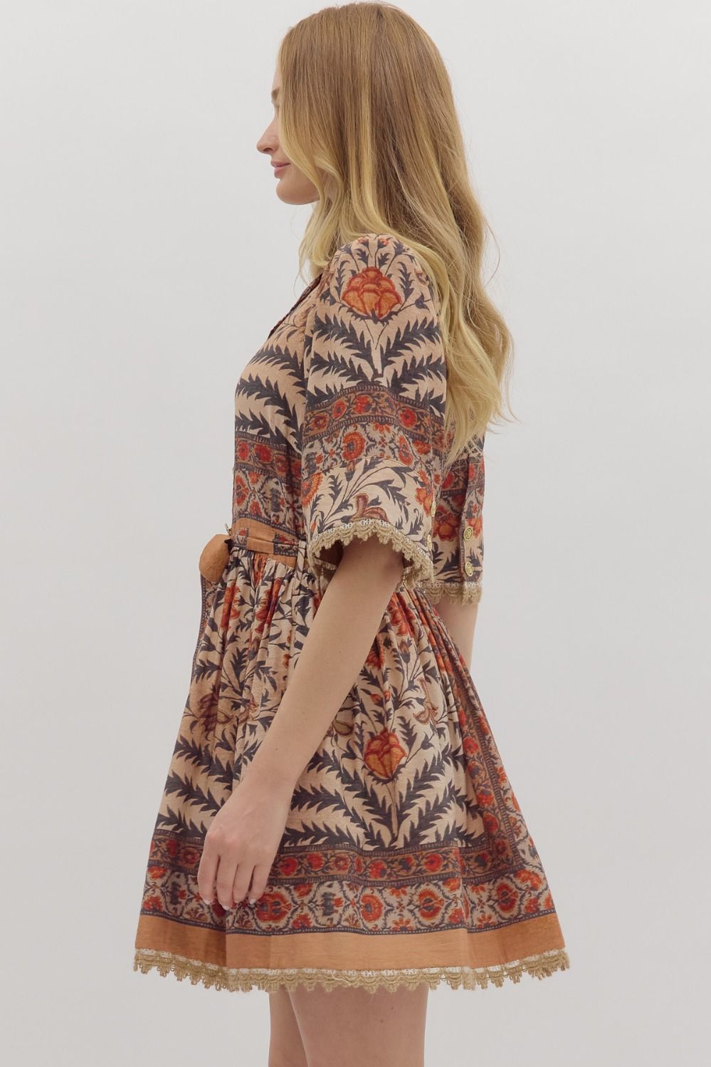 Bold and feminine, the Beatrix mini dress mixes botanical print, contrast trim, and lace accents with a flattering, easy-to-wear silhouette.