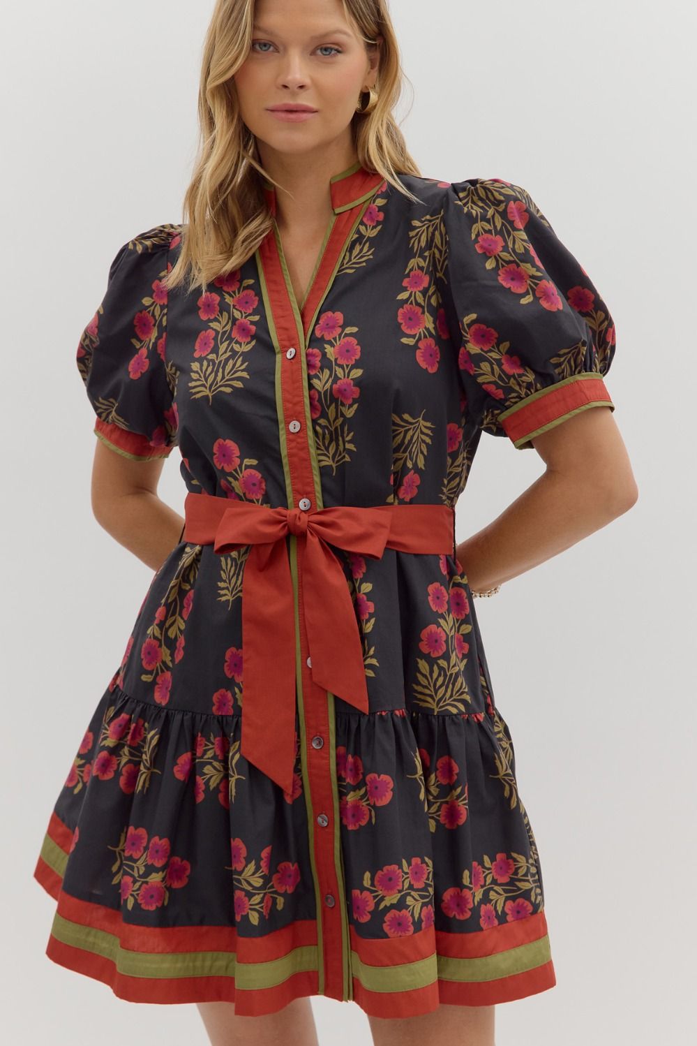 Bright and feminine, the Rosamund mini dress combines a floral print, puff sleeves, and ruffle hem with colorful banded accents.