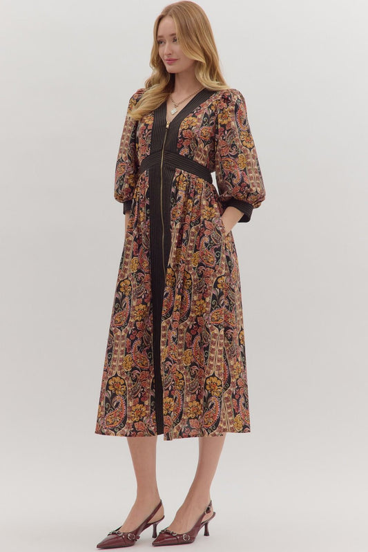 Charming and versatile, the Verena midi dress pairs a bold paisley print with striped trim, puff sleeves, and practical pockets.