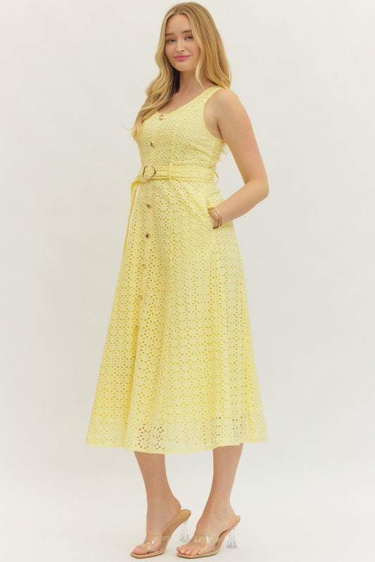 cotton eyelet midi dress with a belted waist, smocked back, and elegant, structured silhouette.