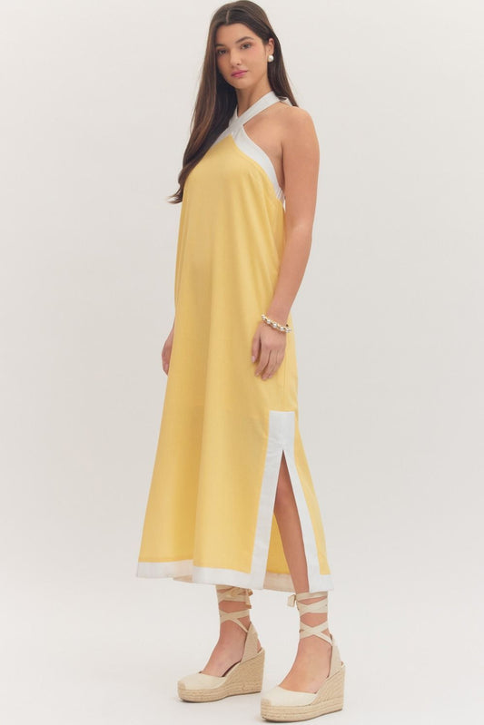 sleeveless midi dress with a cross halter neckline, self-tie back, side pockets, and side slits