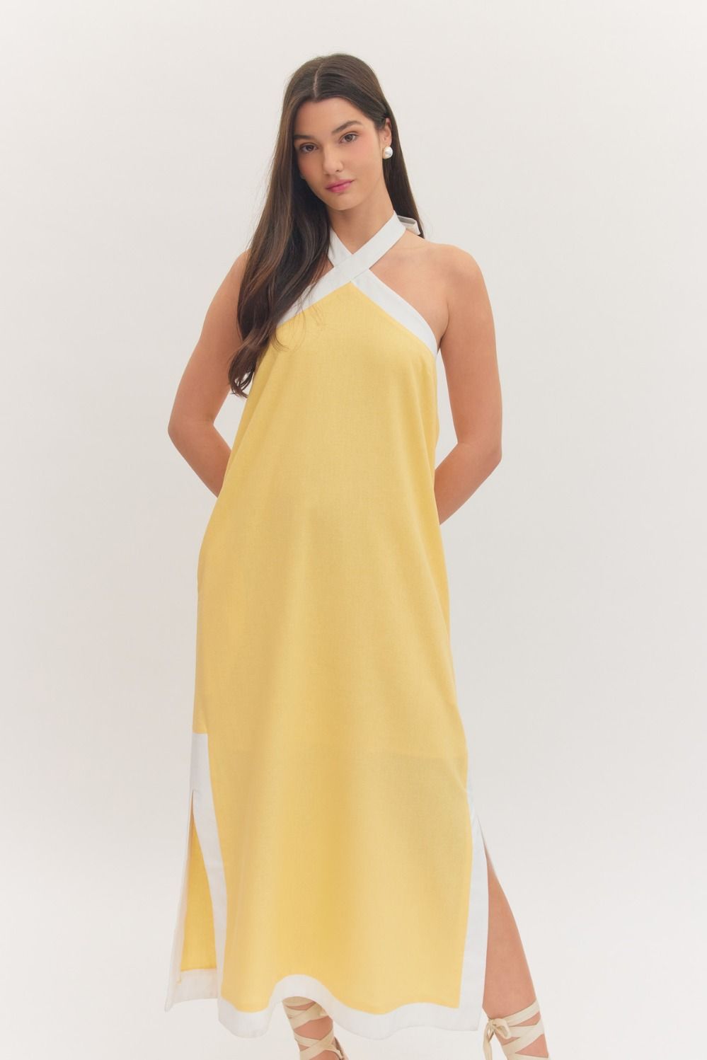 sleeveless midi dress with a cross halter neckline, self-tie back, side pockets, and side slits